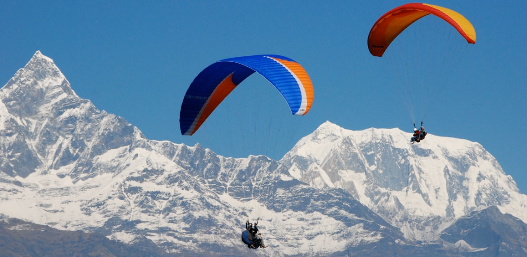 Paragliding in front of the snow-covered Himalayas